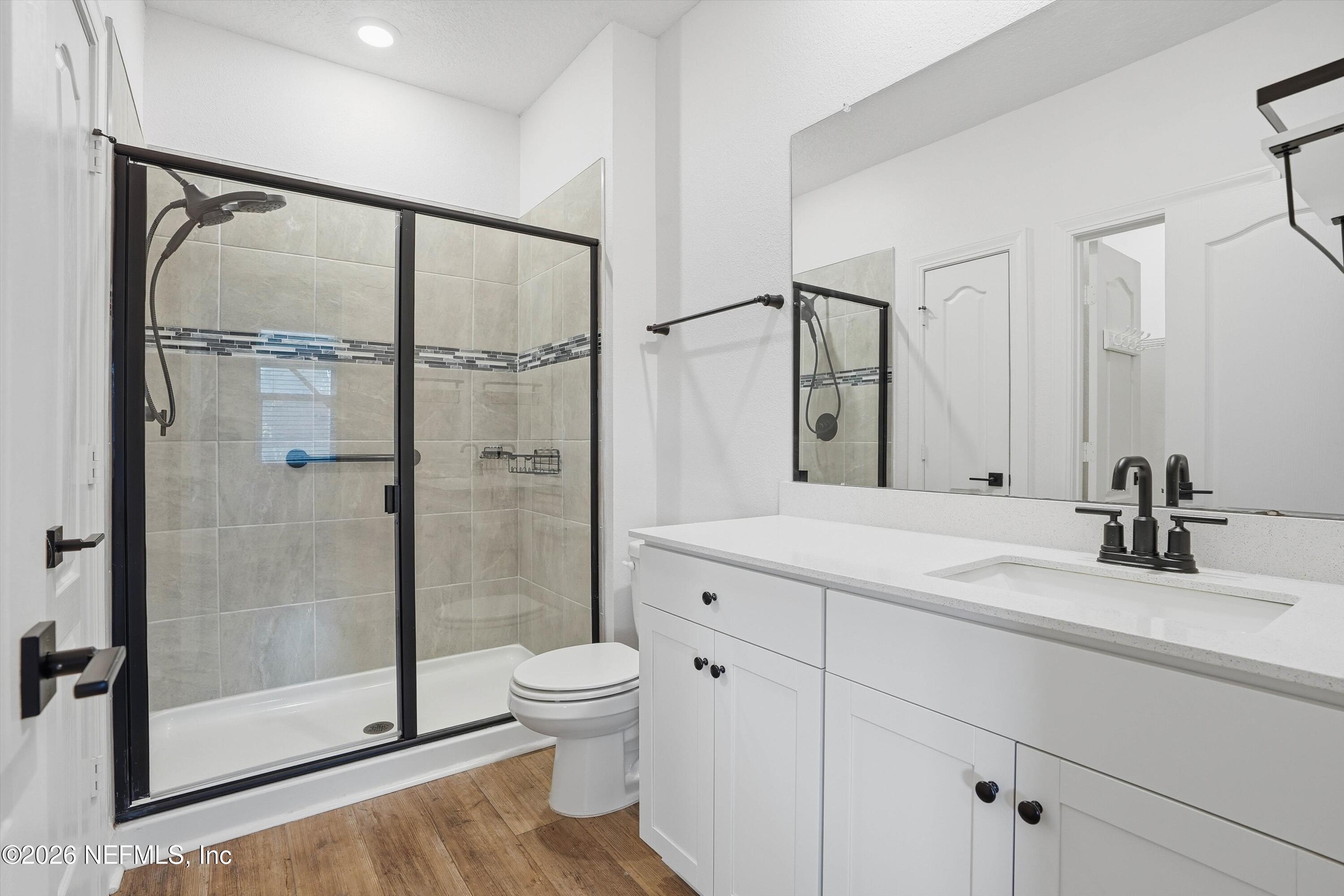 600 Morgans Treasure Road St. Augustine, FL 32084 - Photo 12 of 41 a bathroom with a shower sink vanity mirror and toilet