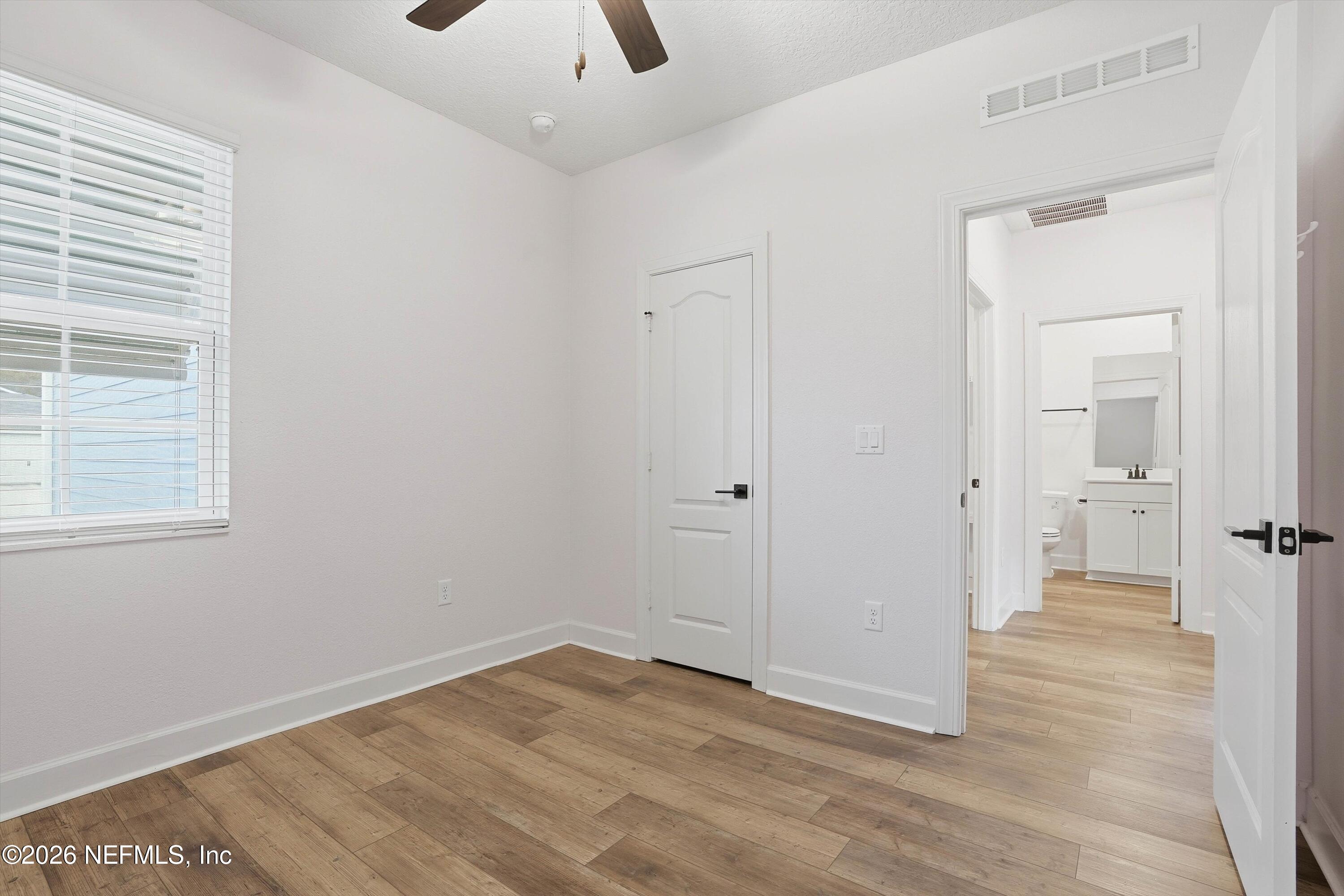 600 Morgans Treasure Road St. Augustine, FL 32084 - Photo 14 of 41 a view of a room with wooden floor and a bathroom