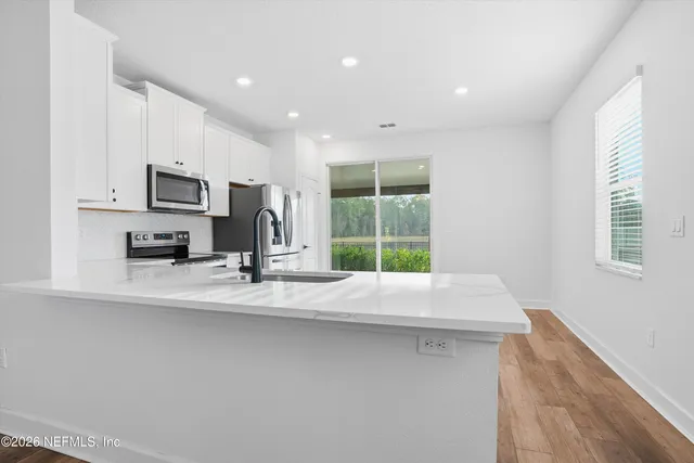 a view of kitchen with furniture and large window