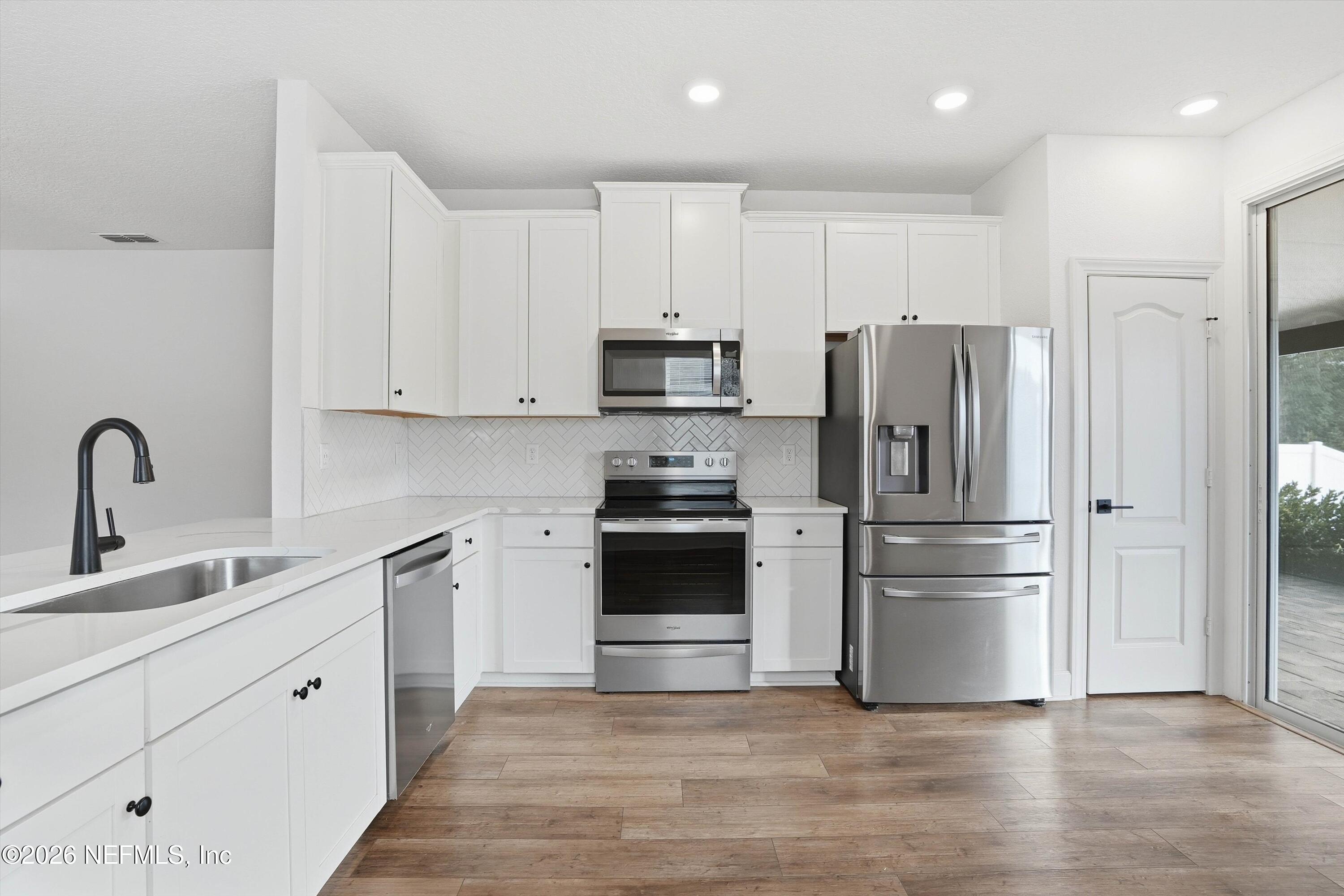 600 Morgans Treasure Road St. Augustine, FL 32084 - Photo 7 of 41 a kitchen with cabinets stainless steel appliances and a sink