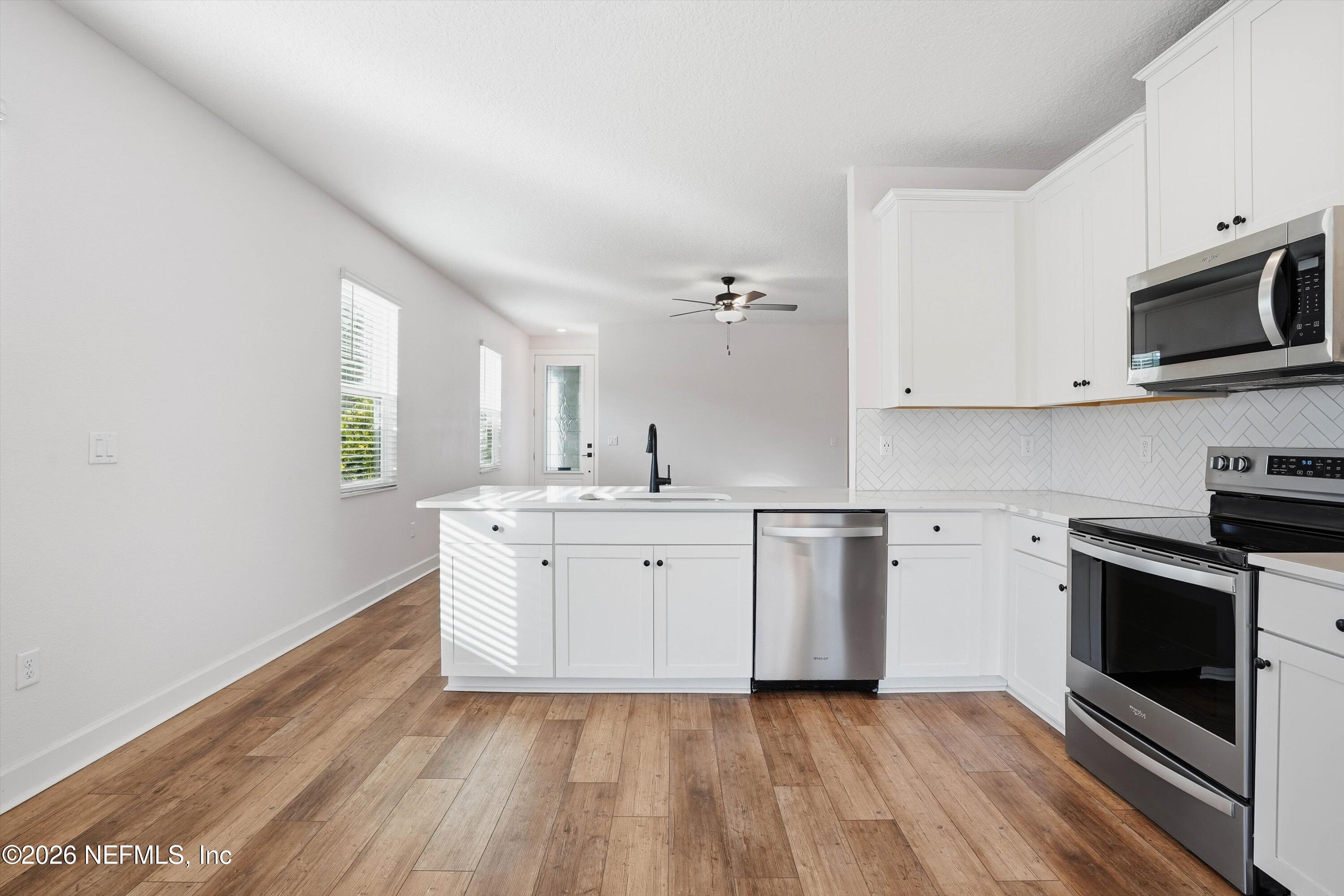 600 Morgans Treasure Road St. Augustine, FL 32084 - Photo 8 of 41 a kitchen with stainless steel appliances granite countertop a stove a sink and a microwave