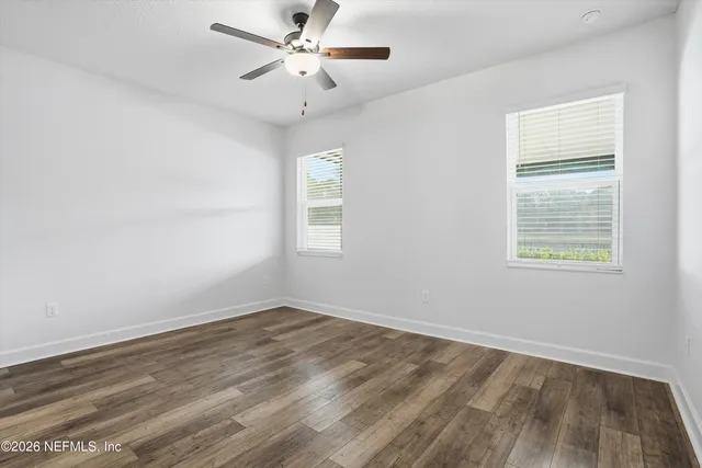 wooden floor in an empty room with a window