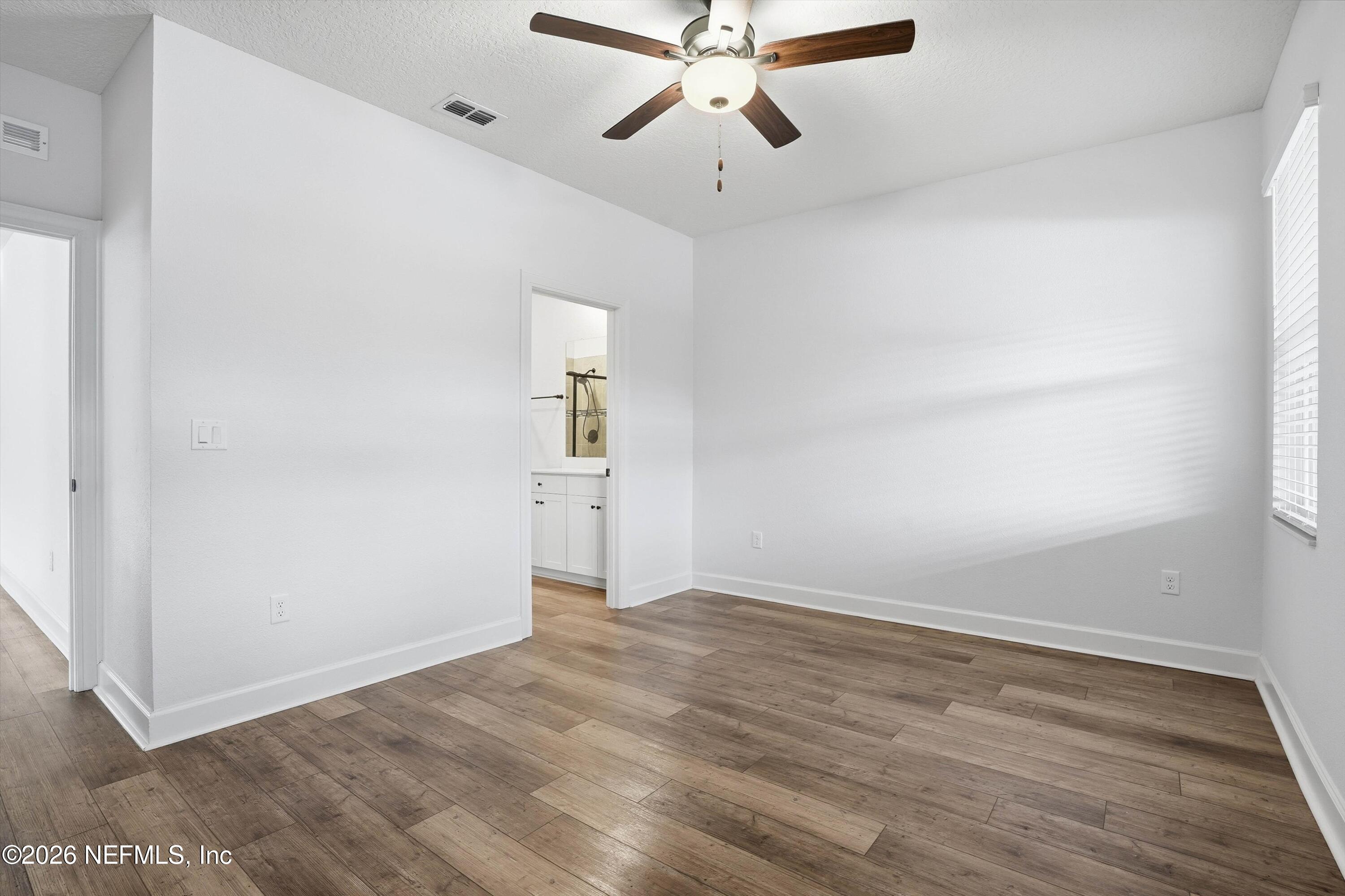 600 Morgans Treasure Road St. Augustine, FL 32084 - Photo 10 of 41 wooden floor in an empty room with a window