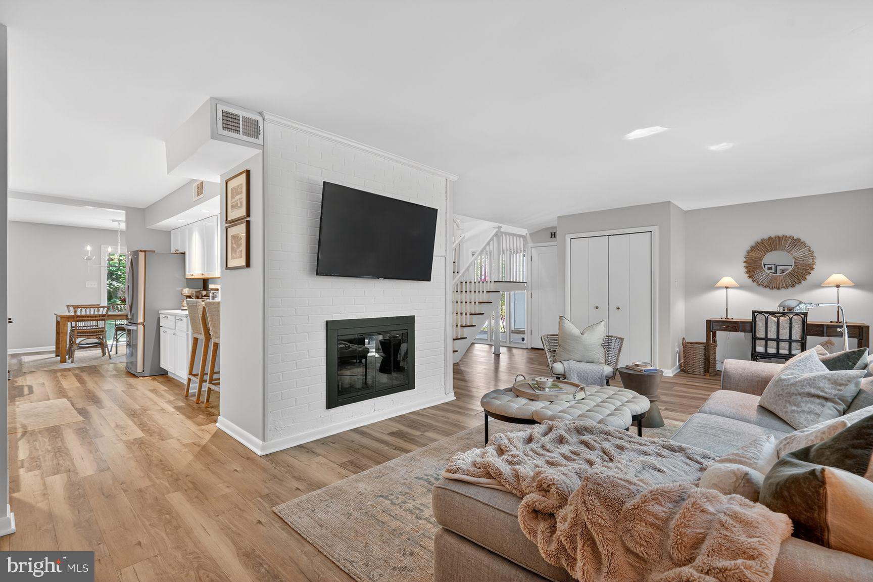 11201 Wedge Drive Reston, VA 20190 - Photo 6 of 31 a living room with furniture a fireplace and a flat screen tv