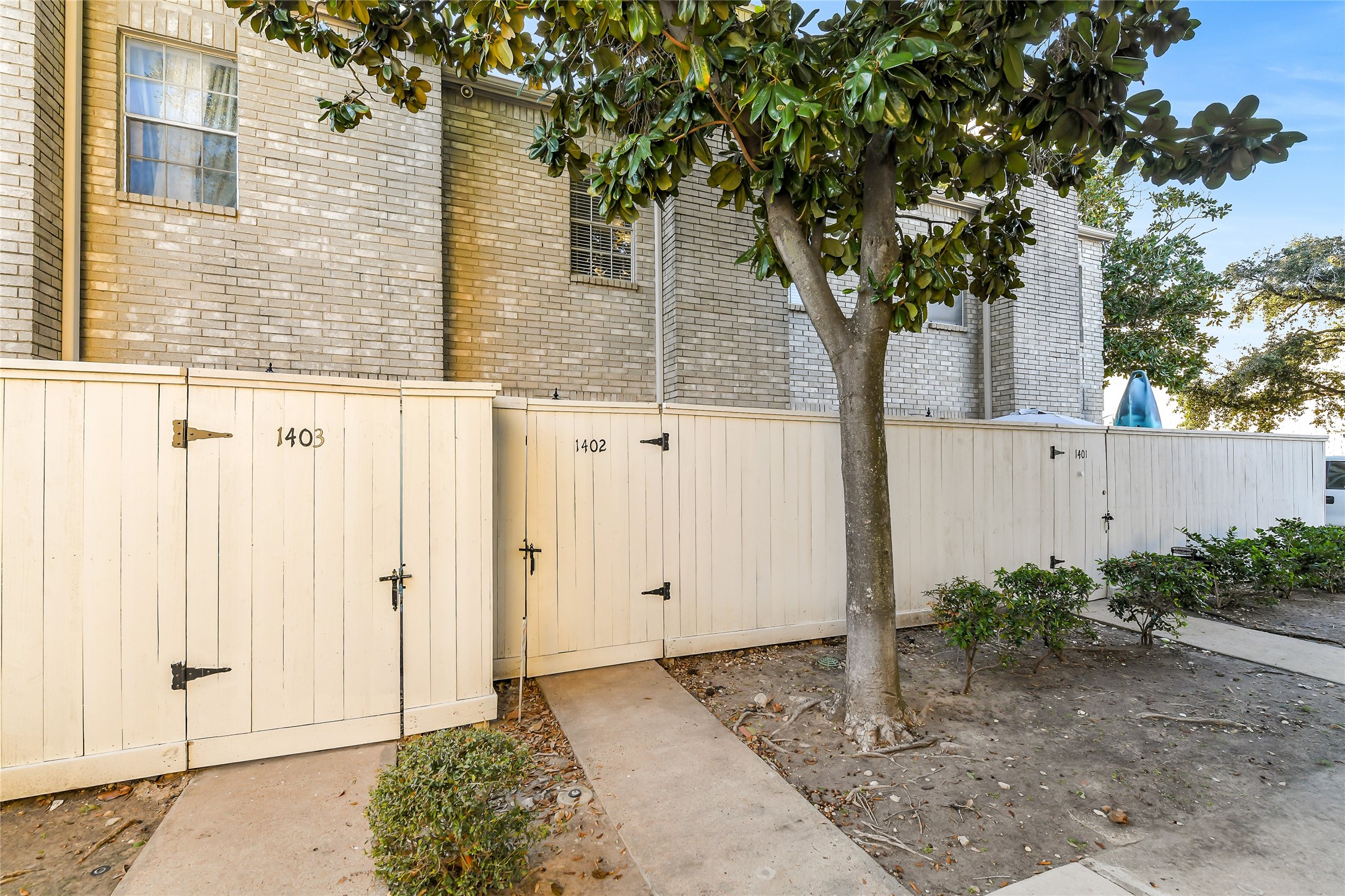 4001 Tanglewilde Street, Unit 1402 Houston, TX 77063 - Photo 2 of 23 a front view of a house with a tree