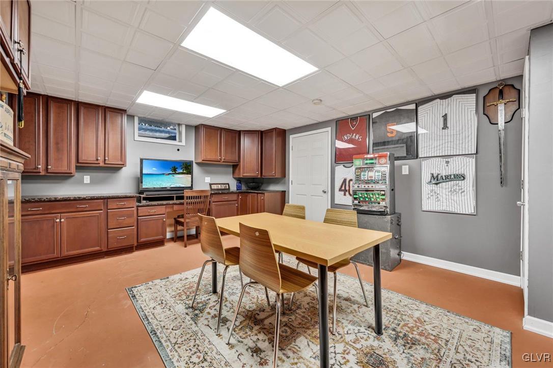 330 Manor Drive Nazareth, PA 18064 - Photo 40 of 51 a kitchen with stainless steel appliances granite countertop a table chairs sink and cabinets