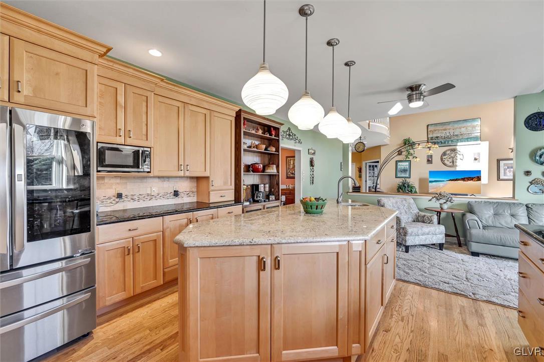 330 Manor Drive Nazareth, PA 18064 - Photo 10 of 51 a kitchen with stainless steel appliances granite countertop a sink a stove and a wooden floors