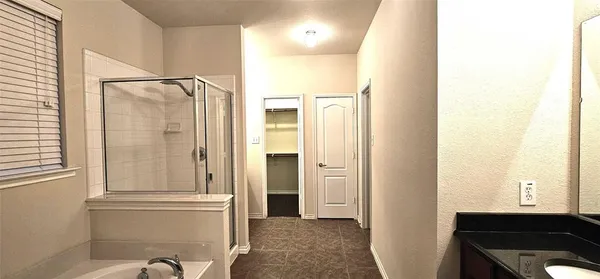 a view of a hallway with furniture and a window
