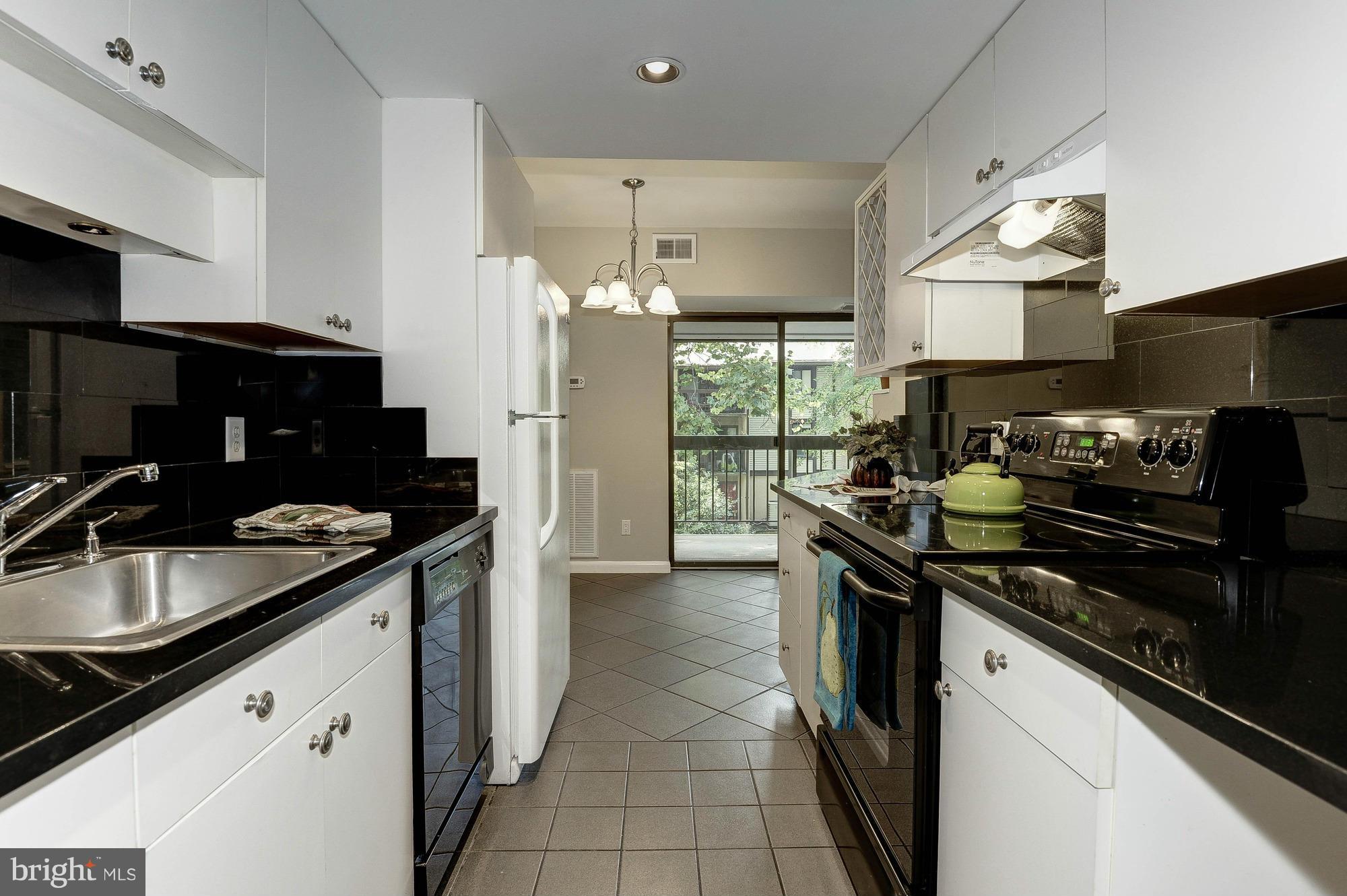 11649 Stoneview Square, Unit 22C Reston, VA 20191 - Photo 5 of 30 Kitchen long view to balcony