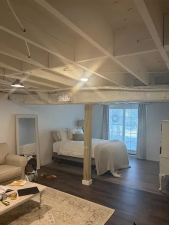 a bedroom with furniture and wooden floor