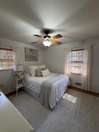 a spacious bedroom with a bed and a window