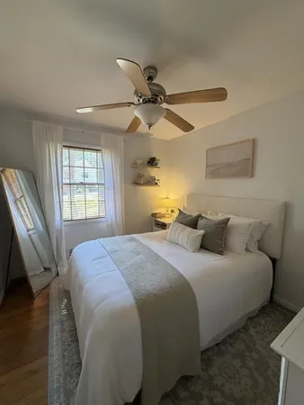 a bedroom with a bed and a window