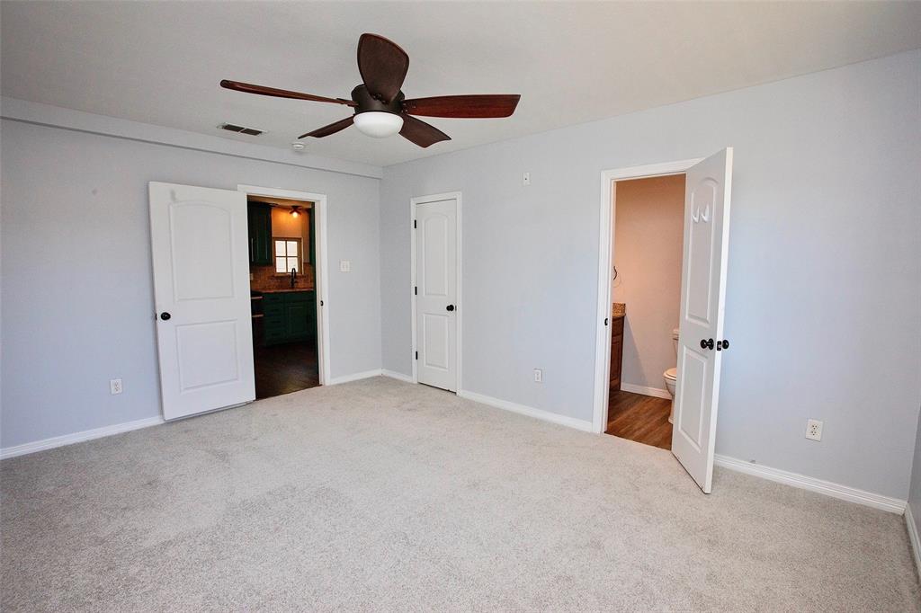 1214 3rd Street Graham, TX 76450 - Photo 11 of 23 a view of a livingroom with a ceiling fan & entryway