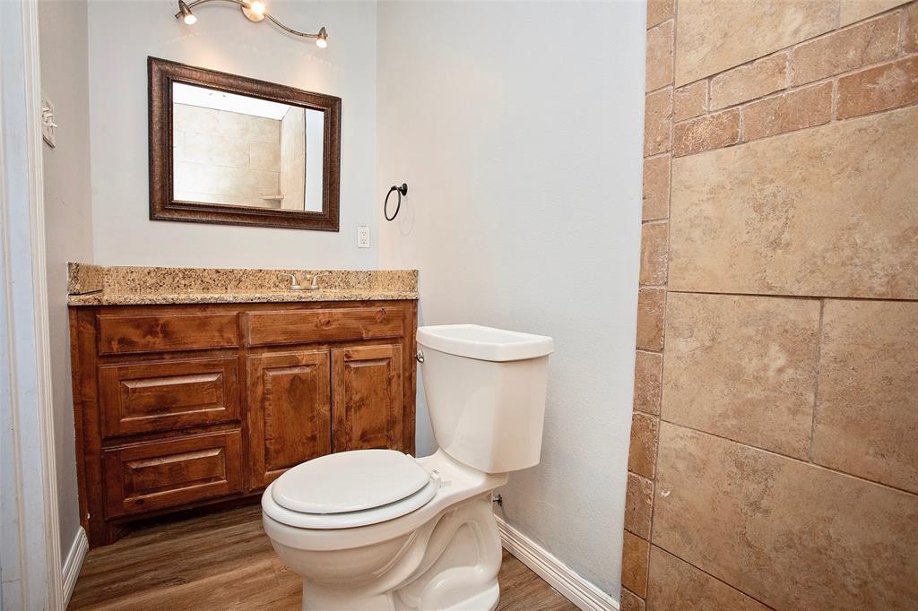 1214 3rd Street Graham, TX 76450 - Photo 13 of 23 a bathroom with a toilet and a sink