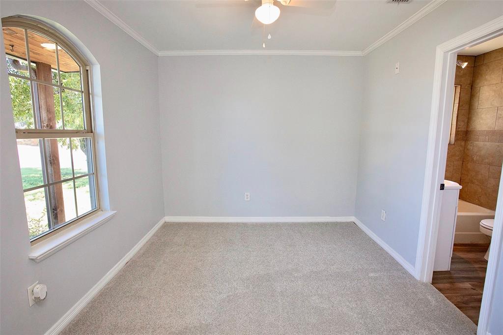 1214 3rd Street Graham, TX 76450 - Photo 15 of 23 a view of an empty room with a window