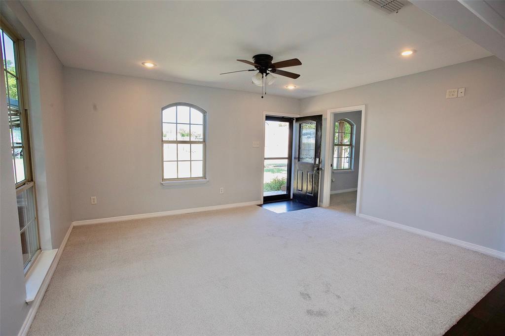 1214 3rd Street Graham, TX 76450 - Photo 17 of 23 an empty room with windows and ceiling fan