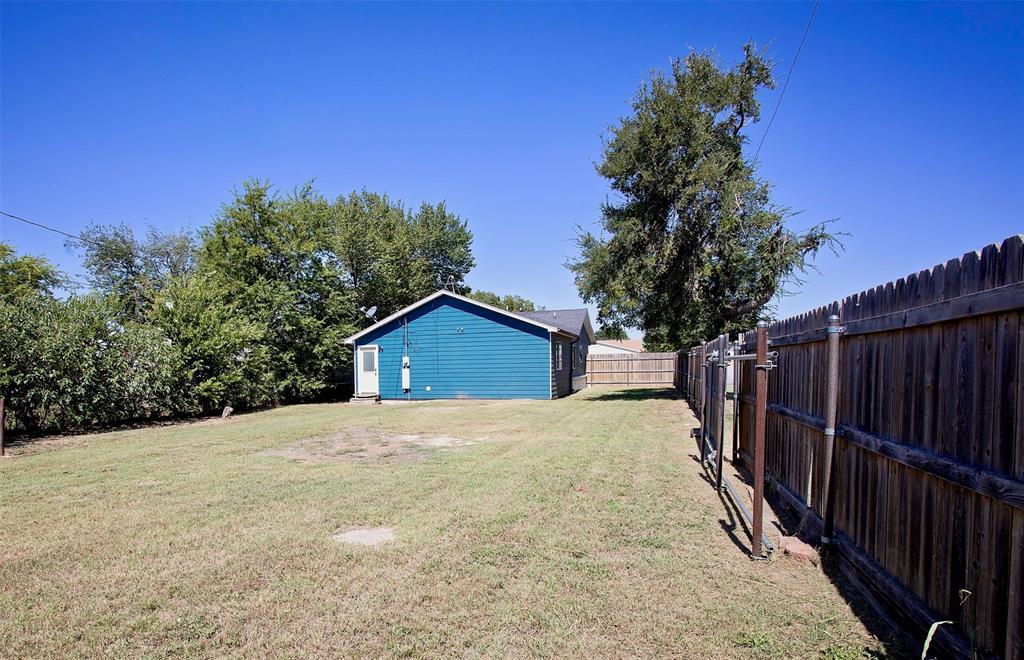 1214 3rd Street Graham, TX 76450 - Photo 23 of 23 a view of a wooden fence under a large tree