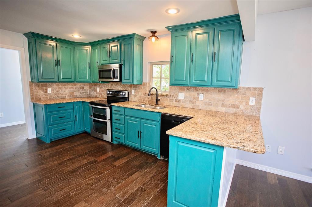 1214 3rd Street Graham, TX 76450 - Photo 5 of 23 a kitchen with cabinets and window