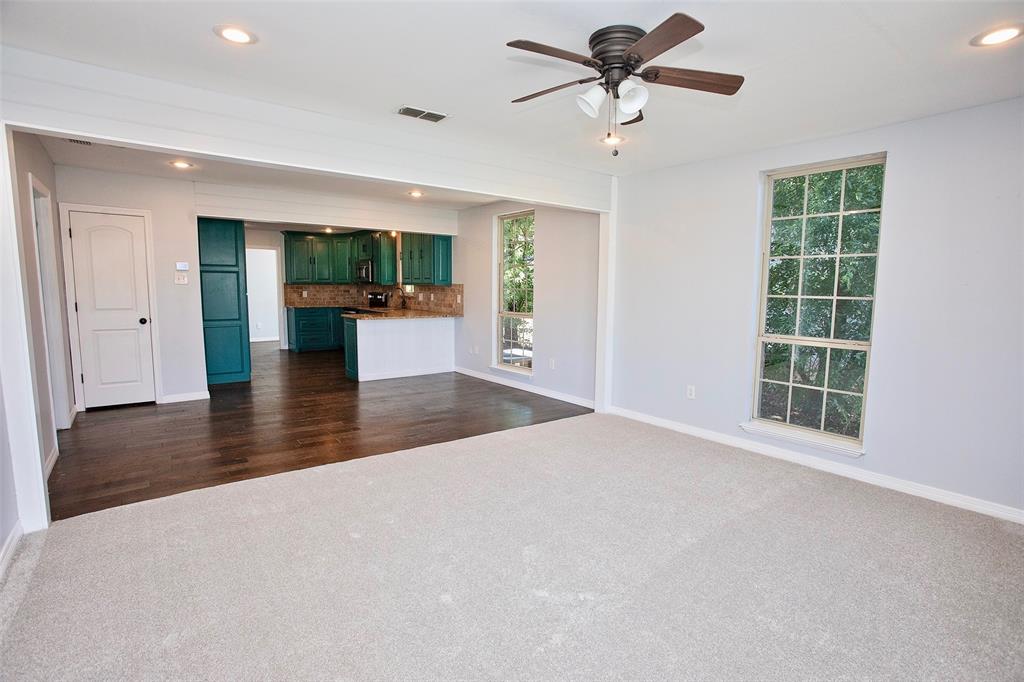 1214 3rd Street Graham, TX 76450 - Photo 7 of 23 a view of an empty room with a window and kitchen view