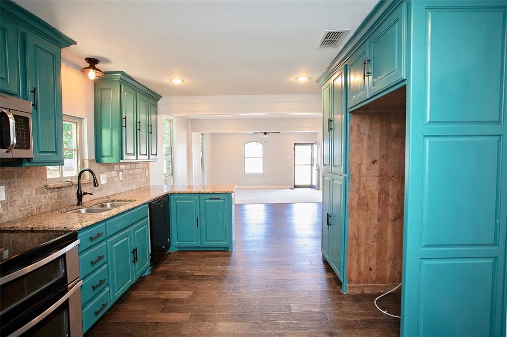 1214 3rd Street Graham, TX 76450 - Photo 9 of 23 a kitchen with lots of counter space and a sink