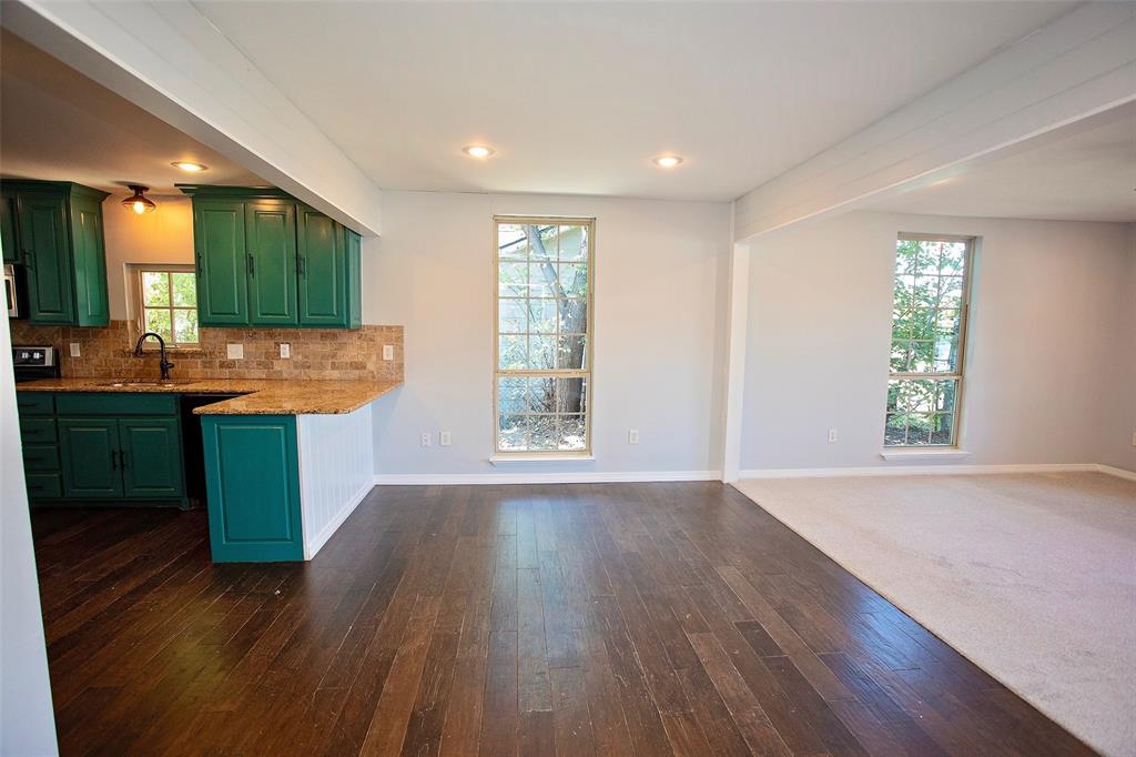 1214 3rd Street Graham, TX 76450 - Photo 10 of 23 an empty room with wooden floor and window