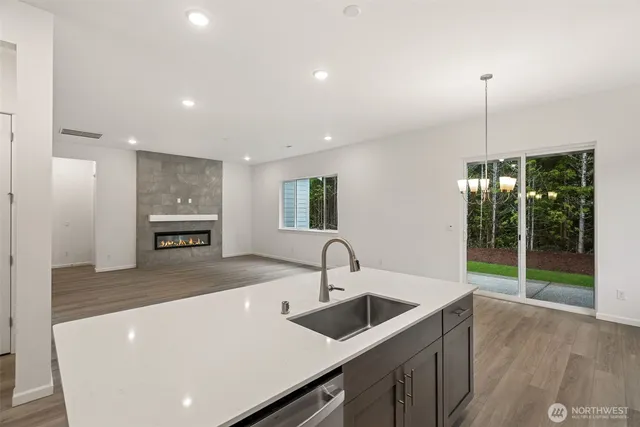 a kitchen with kitchen island a sink stainless steel appliances and a counter top space