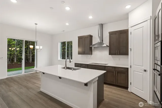 a kitchen with stainless steel appliances a sink stove and refrigerator