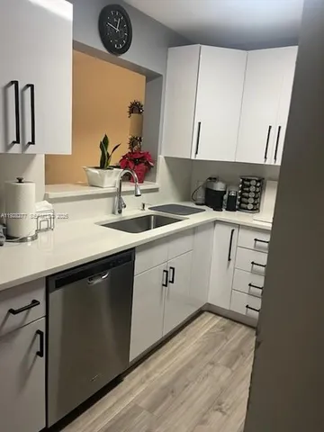 a kitchen with a sink cabinets and window