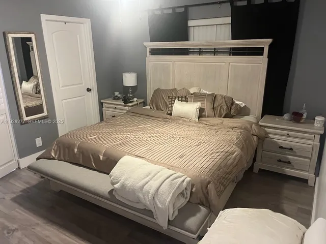 a bedroom with a bed and a mirror