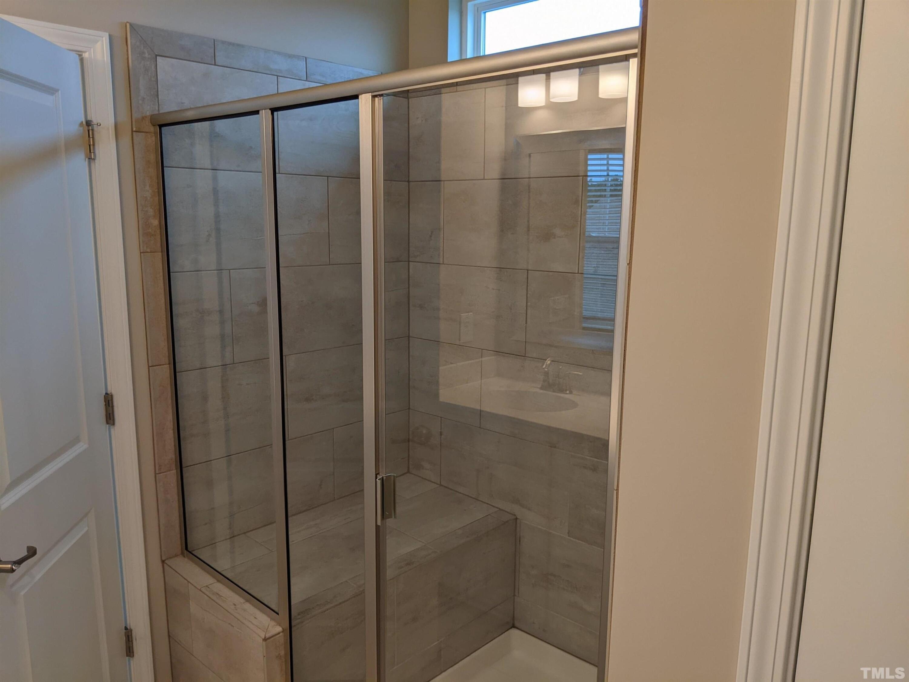 1976 Austin Ridge Parkway Wake Forest, NC 27587 - Photo 16 of 21 a bathroom with a glass shower door
