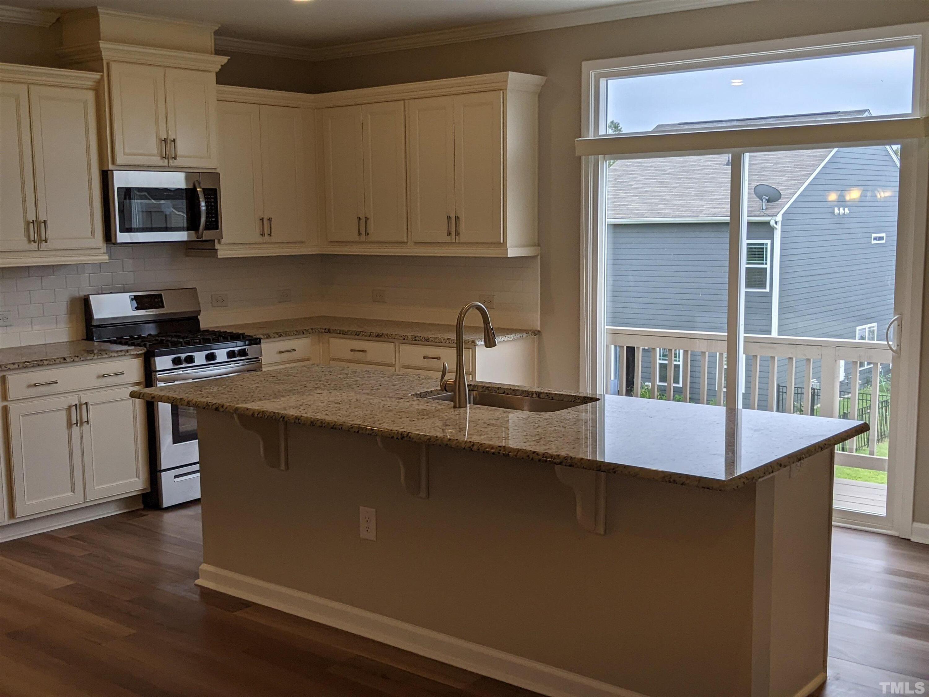 1976 Austin Ridge Parkway Wake Forest, NC 27587 - Photo 7 of 21 a kitchen with stainless steel appliances granite countertop a sink a stove and a microwave