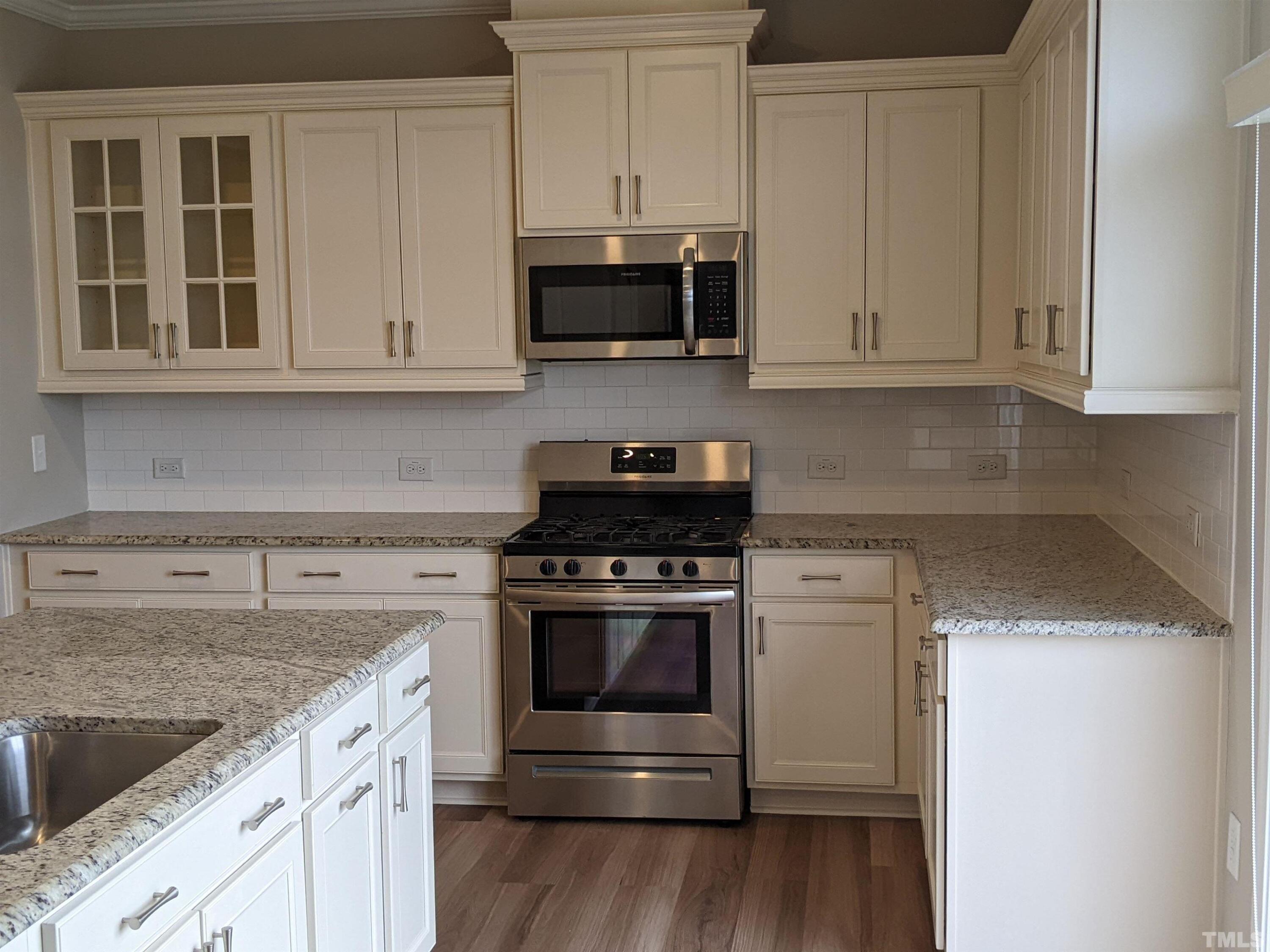 1976 Austin Ridge Parkway Wake Forest, NC 27587 - Photo 8 of 21 a kitchen with granite countertop white cabinets and stainless steel appliances