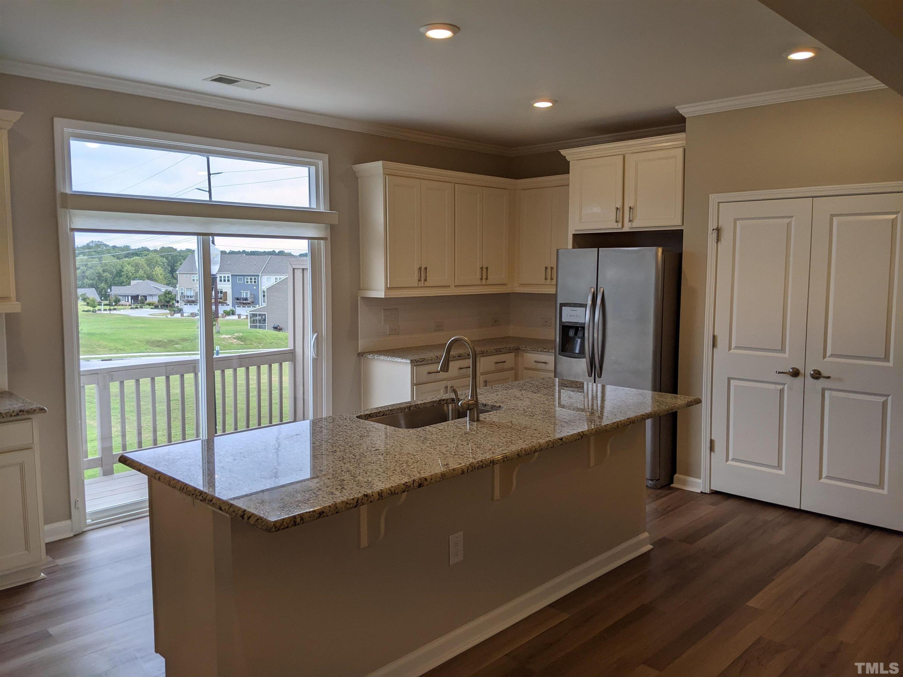1976 Austin Ridge Parkway Wake Forest, NC 27587 - Photo 9 of 21 a kitchen with granite countertop a refrigerator and a sink