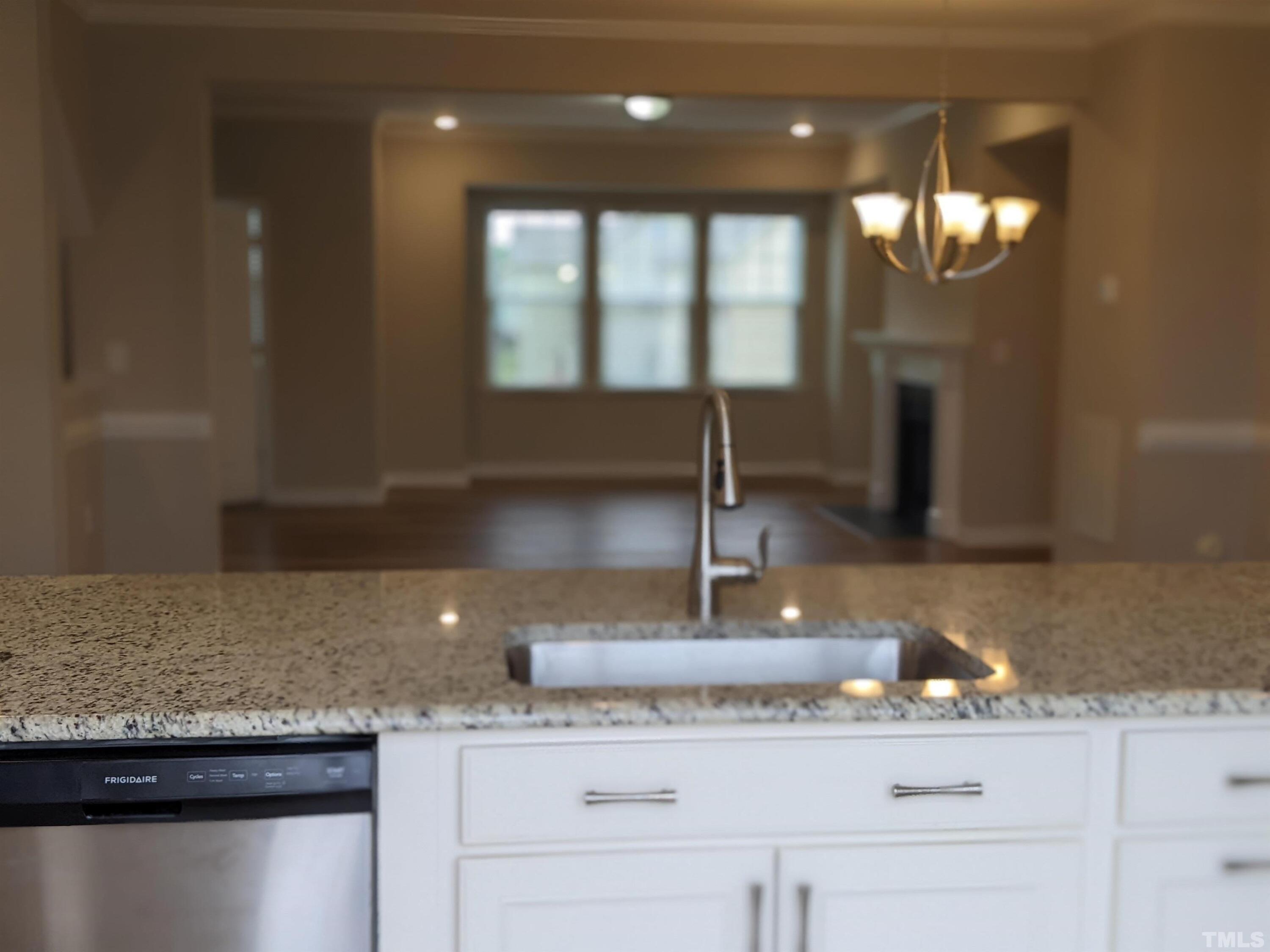 1976 Austin Ridge Parkway Wake Forest, NC 27587 - Photo 10 of 21 a kitchen with granite countertop kitchen island white cabinets and window