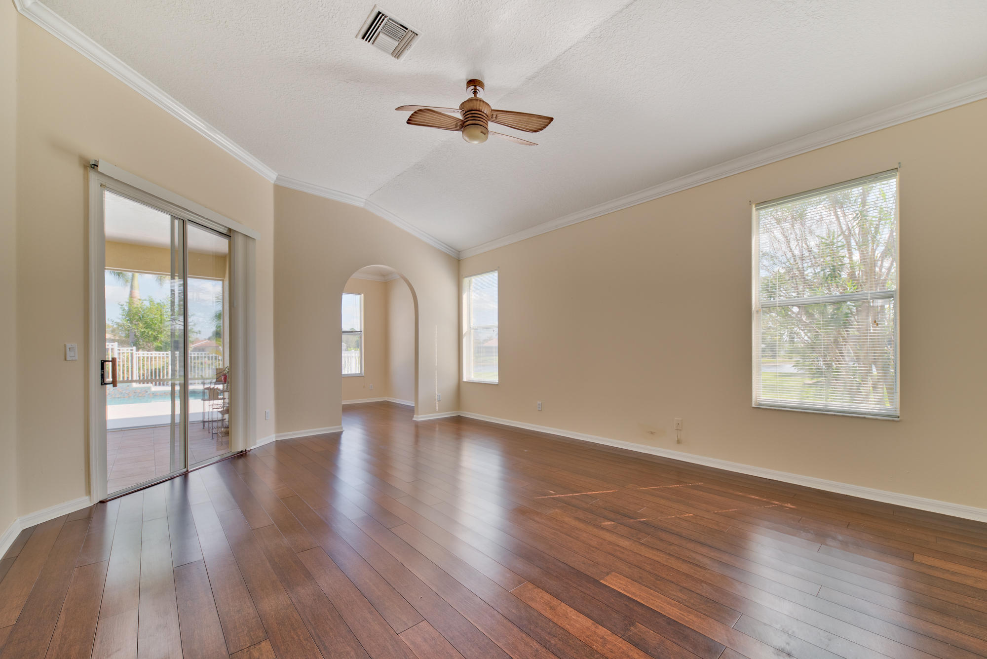 567 Southwest Spring Hill Point Port St. Lucie, FL 34986 - Photo 13 of 36 a view of an empty room with wooden floor and a window