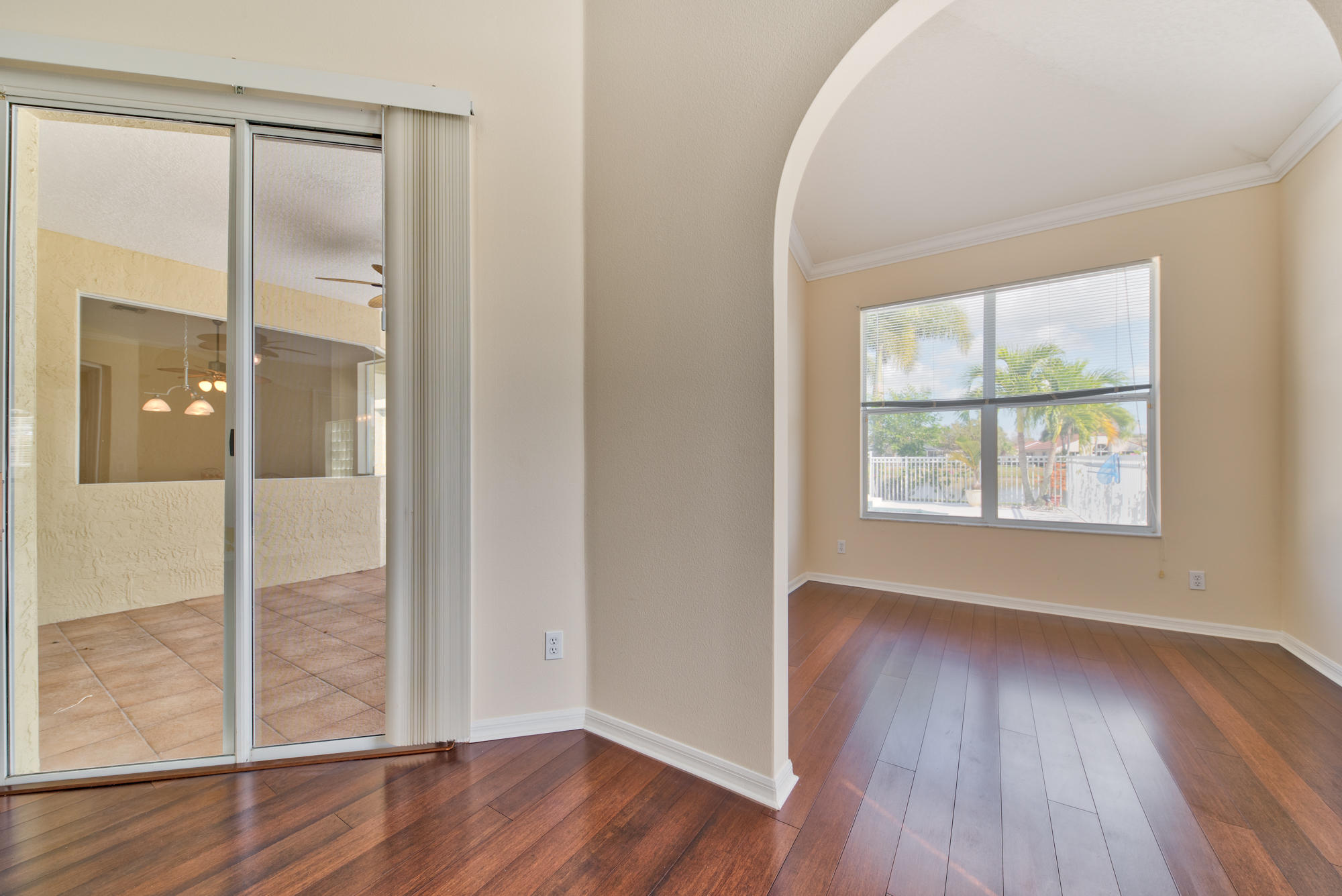 567 Southwest Spring Hill Point Port St. Lucie, FL 34986 - Photo 14 of 36 an empty room with wooden floor and windows