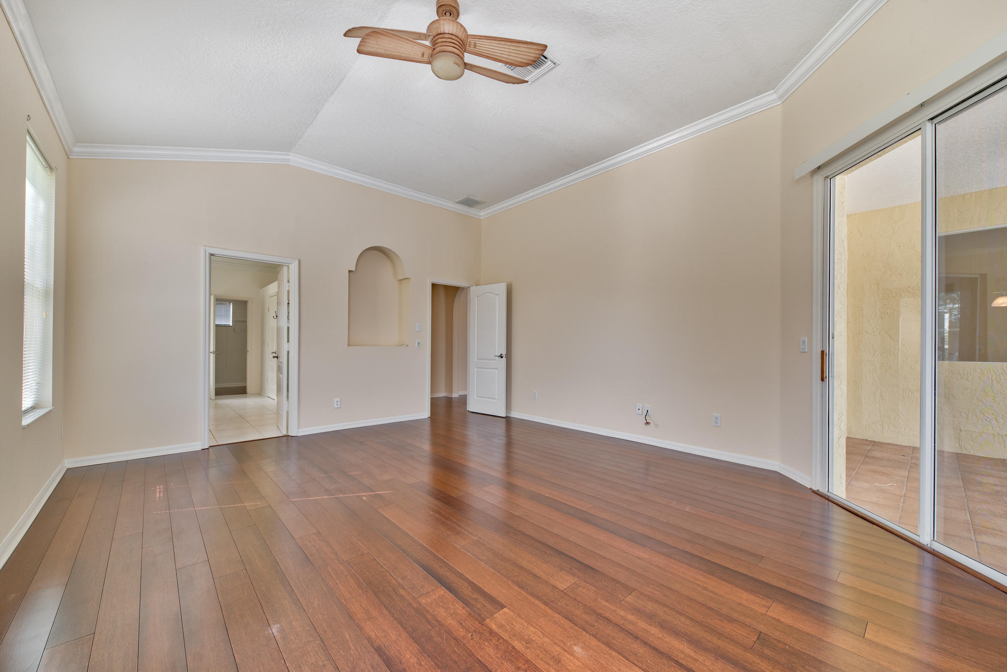 567 Southwest Spring Hill Point Port St. Lucie, FL 34986 - Photo 15 of 36 a view of an empty room with wooden floor and a window