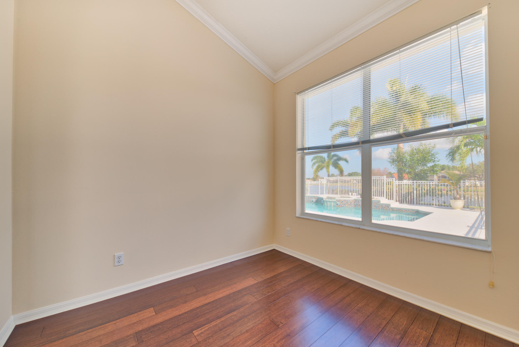 567 Southwest Spring Hill Point Port St. Lucie, FL 34986 - Photo 16 of 36 a view of an empty room with wooden floor and a window
