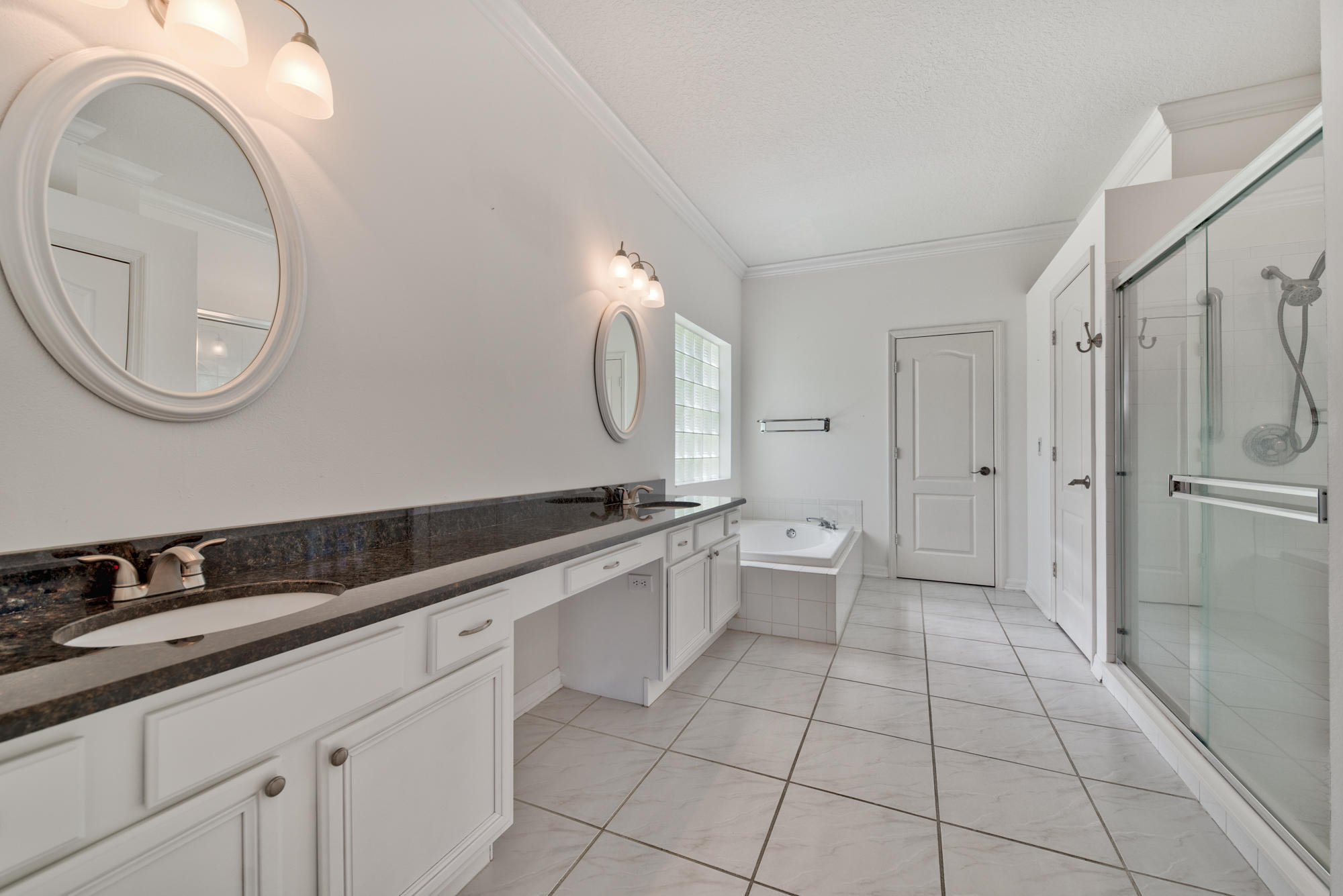 567 Southwest Spring Hill Point Port St. Lucie, FL 34986 - Photo 18 of 36 a large bathroom with a granite countertop sink a toilet and a mirror