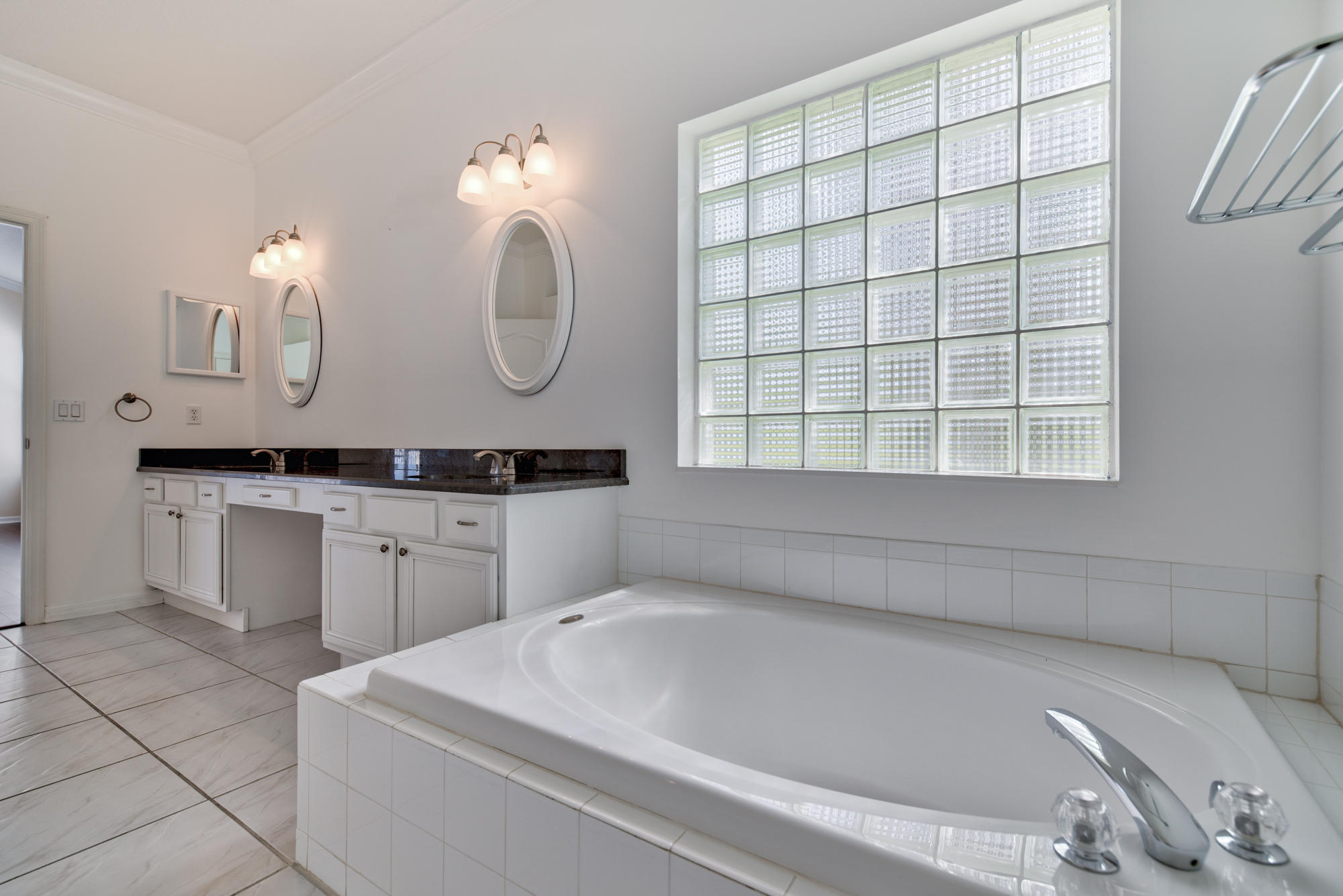 567 Southwest Spring Hill Point Port St. Lucie, FL 34986 - Photo 19 of 36 a bathroom with a sink and a mirror