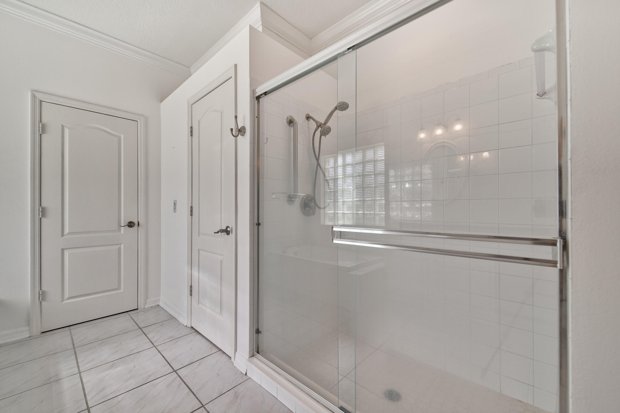 567 Southwest Spring Hill Point Port St. Lucie, FL 34986 - Photo 20 of 36 a bathroom with a glass shower door