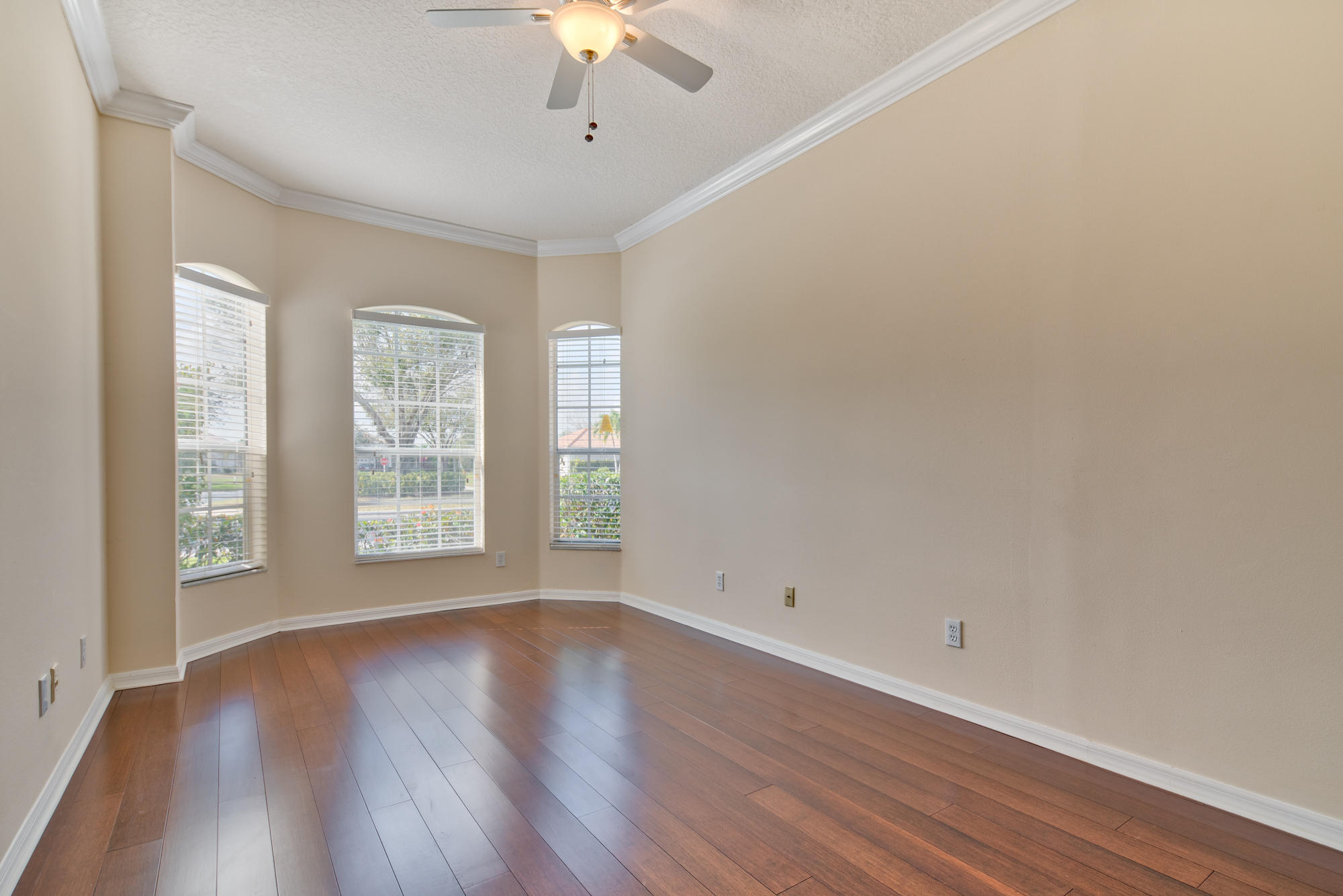 567 Southwest Spring Hill Point Port St. Lucie, FL 34986 - Photo 21 of 36 an empty room with wooden floor and windows