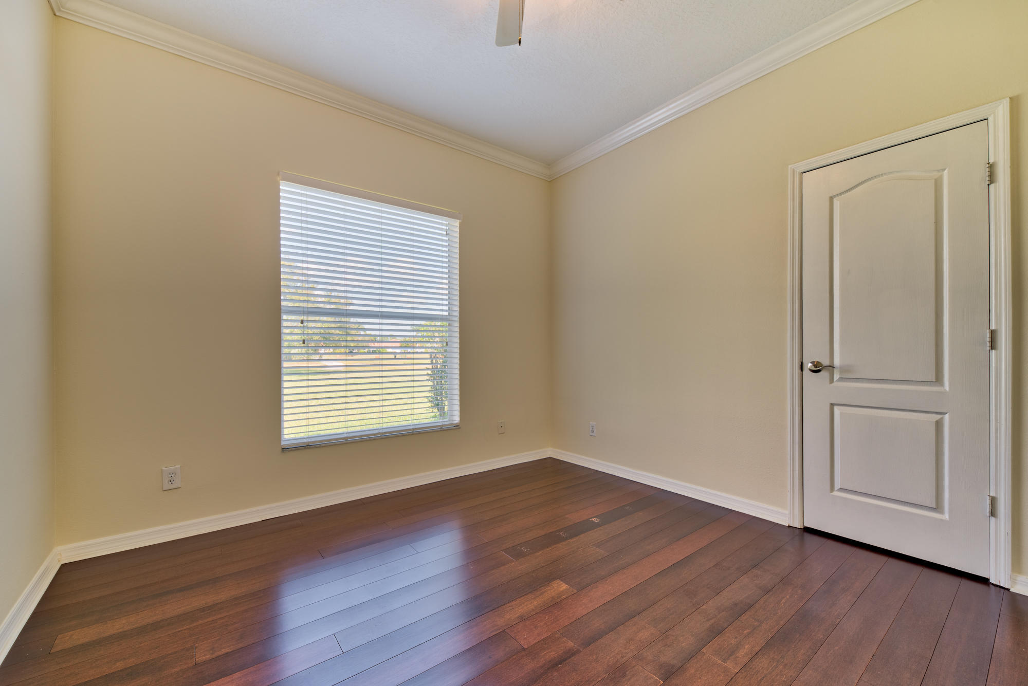 567 Southwest Spring Hill Point Port St. Lucie, FL 34986 - Photo 22 of 36 a view of an empty room with wooden floor and a window
