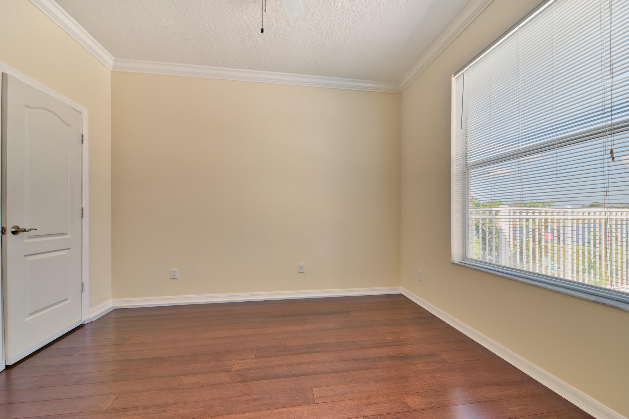 567 Southwest Spring Hill Point Port St. Lucie, FL 34986 - Photo 26 of 36 a view of an empty room with wooden floor and a window