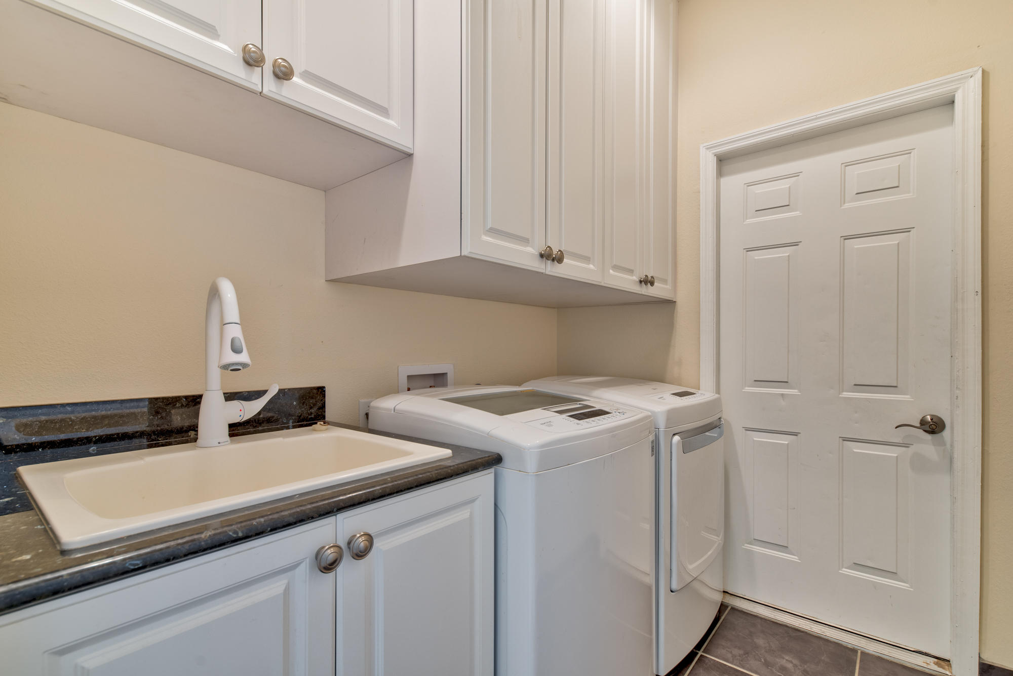 567 Southwest Spring Hill Point Port St. Lucie, FL 34986 - Photo 28 of 36 a utility room with dryer and washer