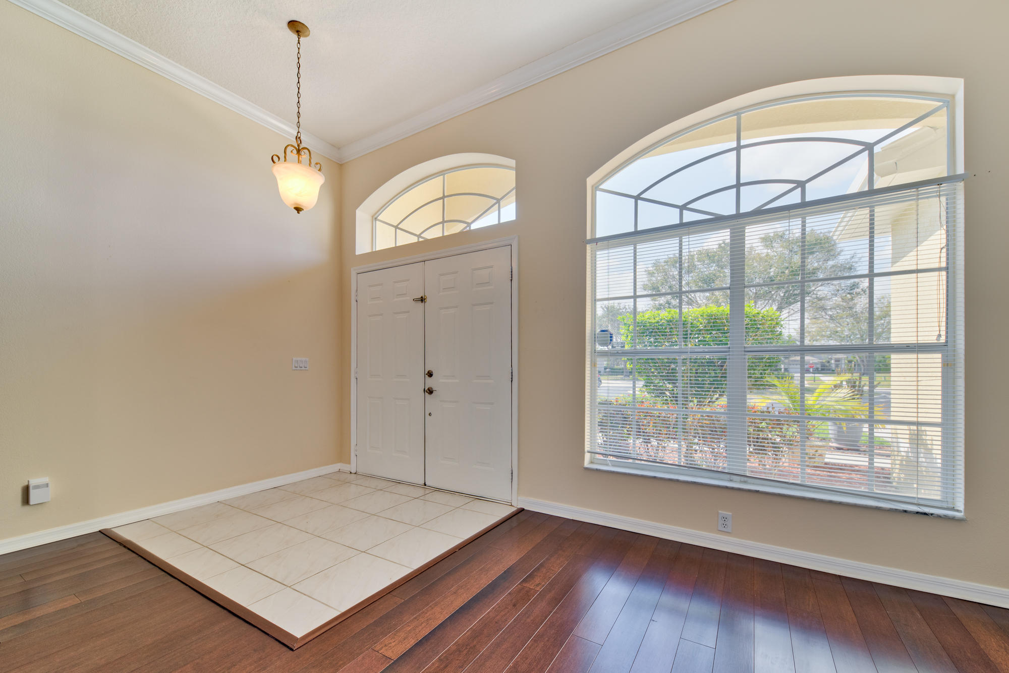 567 Southwest Spring Hill Point Port St. Lucie, FL 34986 - Photo 3 of 36 a view of an empty room with wooden floor and a window