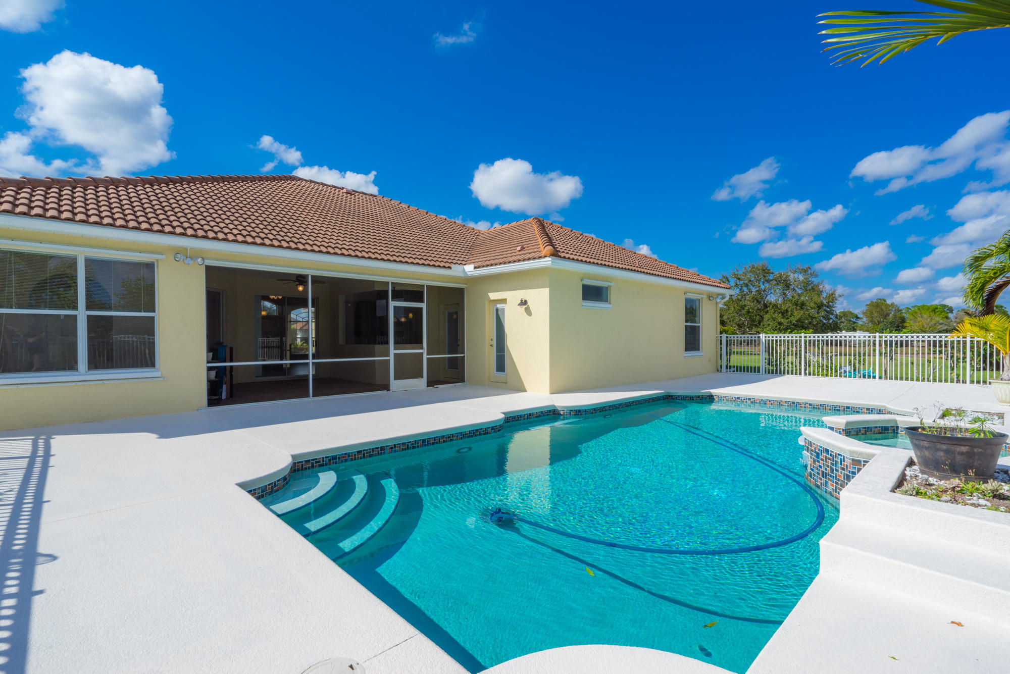 567 Southwest Spring Hill Point Port St. Lucie, FL 34986 - Photo 31 of 36 a view of a house with a swimming pool and sitting area
