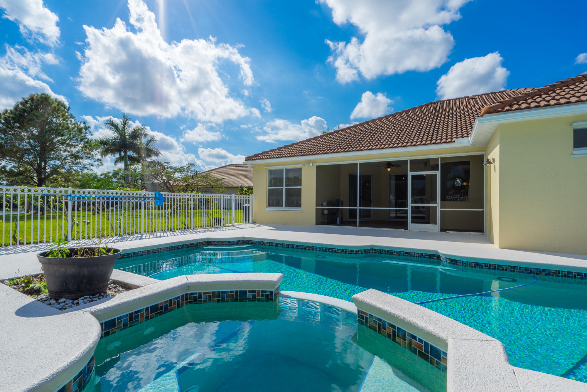 567 Southwest Spring Hill Point Port St. Lucie, FL 34986 - Photo 32 of 36 a view of a house with a swimming pool and a yard