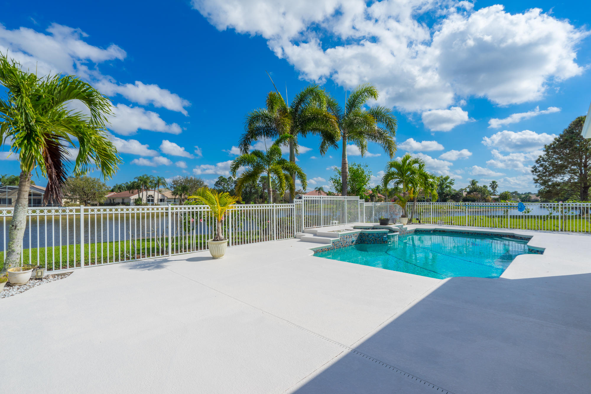 567 Southwest Spring Hill Point Port St. Lucie, FL 34986 - Photo 33 of 36 a view of a swimming pool with a patio and a yard