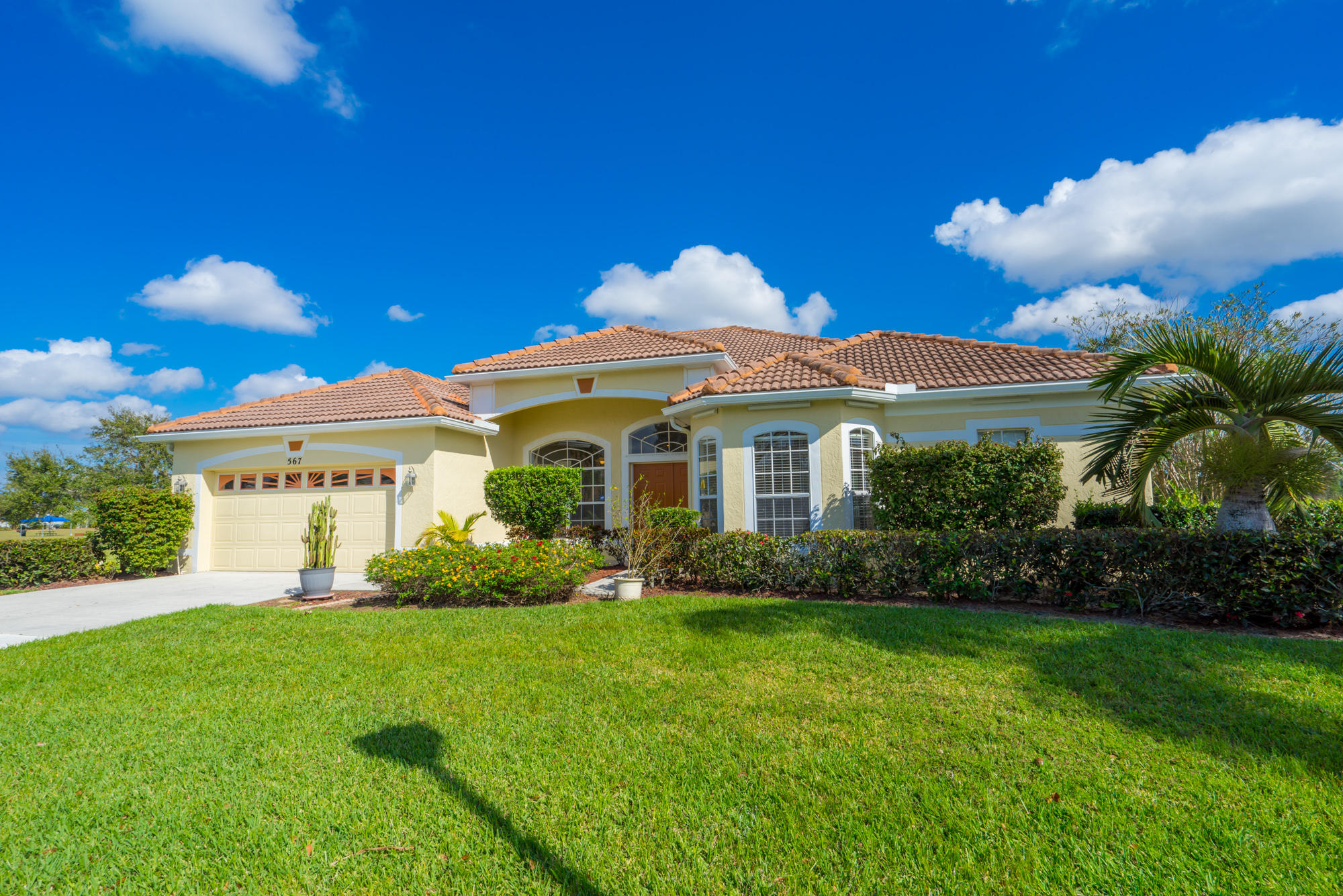 567 Southwest Spring Hill Point Port St. Lucie, FL 34986 - Photo 34 of 36 a front view of a house with a garden